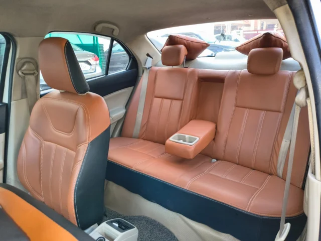 Clean leather rear seats inside Dzire taxi